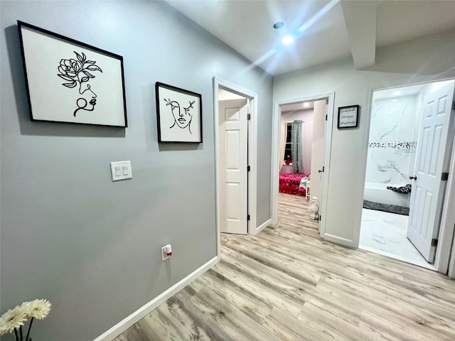 hall with light hardwood / wood-style floors