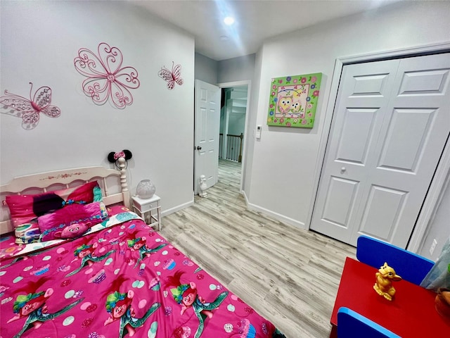 bedroom featuring wood-type flooring and a closet