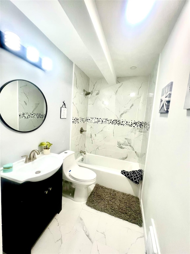 full bathroom featuring tiled shower / bath, vanity, and toilet