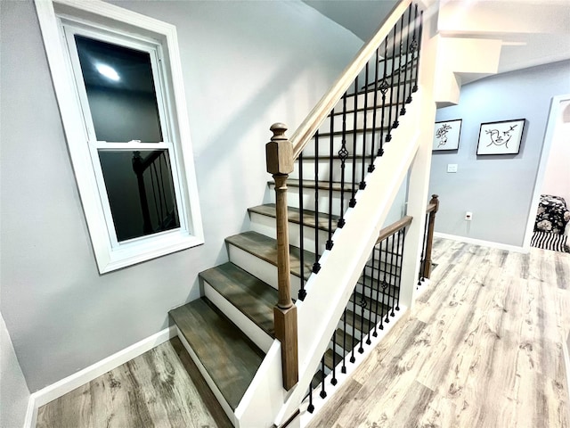 stairs with hardwood / wood-style flooring