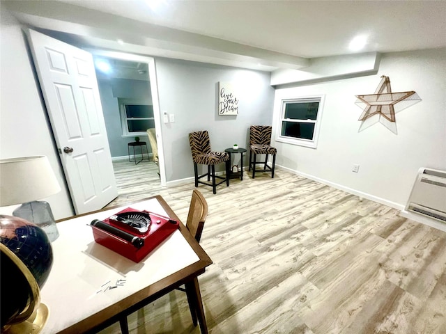 sitting room with light wood-type flooring and heating unit