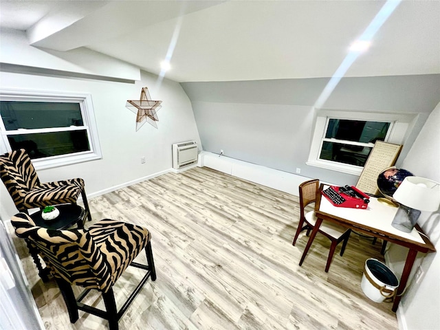 living area featuring light hardwood / wood-style floors and lofted ceiling