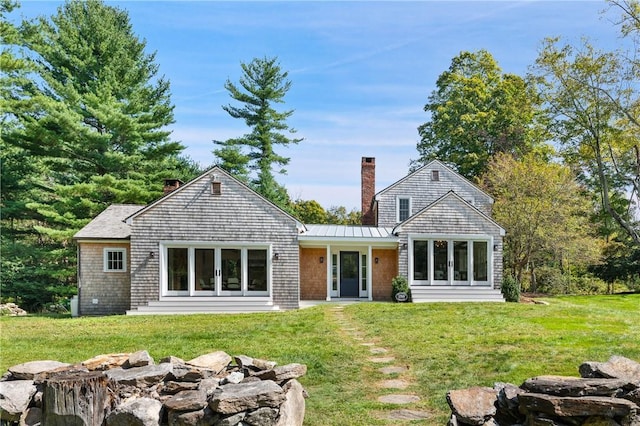 rear view of property featuring a yard