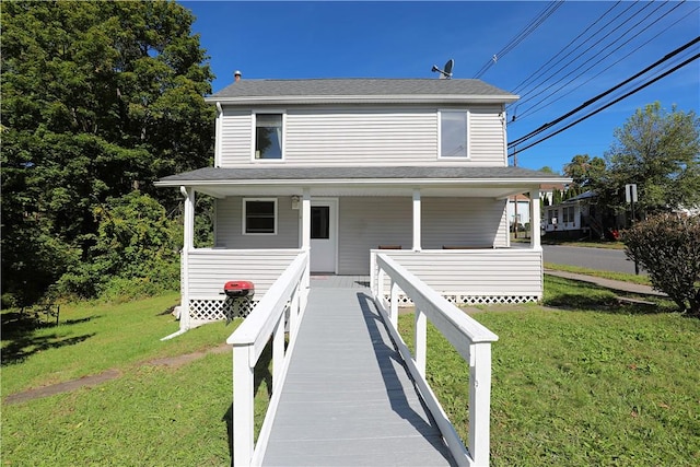 view of front of property with covered porch and a front yard