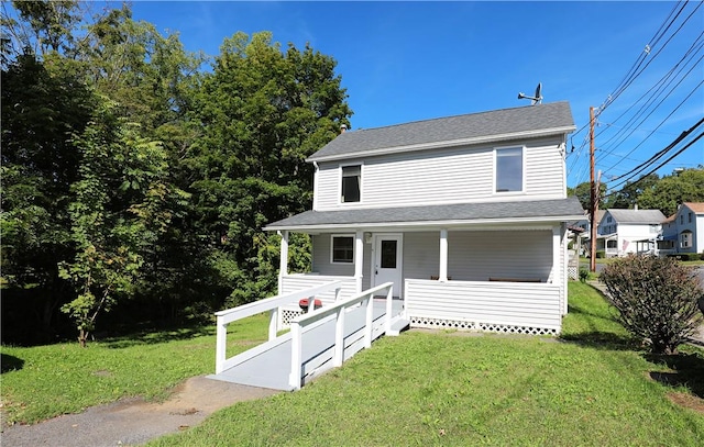 view of front of property with covered porch and a front yard