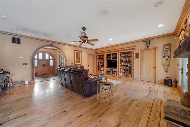 living room featuring ceiling fan, light hardwood / wood-style flooring, and ornamental molding