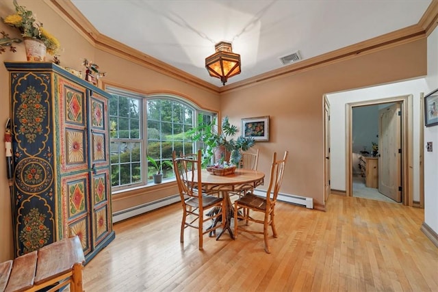 dining space with a baseboard radiator, light hardwood / wood-style flooring, and crown molding