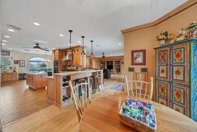 dining area with ceiling fan and light wood-type flooring