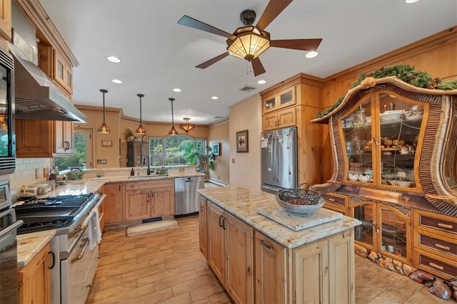 kitchen featuring a center island, backsplash, appliances with stainless steel finishes, decorative light fixtures, and light stone counters