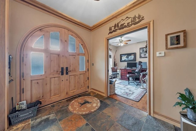 entrance foyer featuring ceiling fan, dark hardwood / wood-style flooring, and ornamental molding