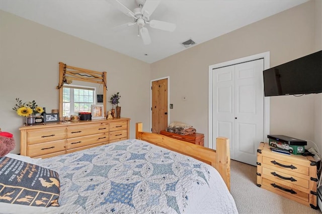 carpeted bedroom featuring ceiling fan and a closet