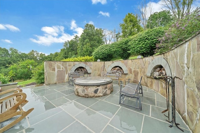 view of patio with a fire pit