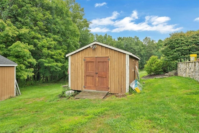 view of outbuilding featuring a yard