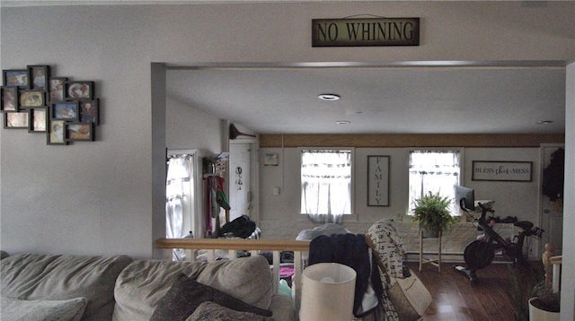 living room with wood-type flooring and lofted ceiling