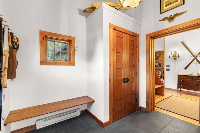 mudroom featuring dark tile patterned flooring and baseboard heating