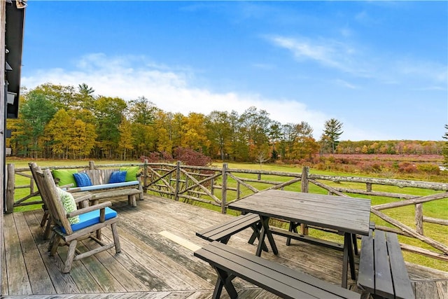 deck with a lawn, a rural view, and an outdoor hangout area