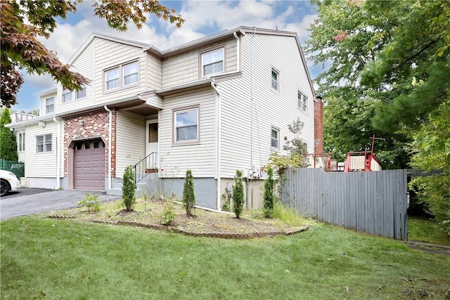 view of front of home with a front yard and a garage