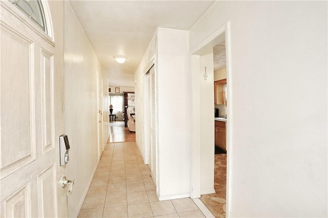 hall featuring light tile patterned flooring