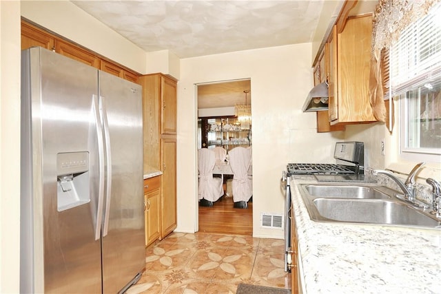 kitchen with sink, stainless steel appliances, and light hardwood / wood-style flooring