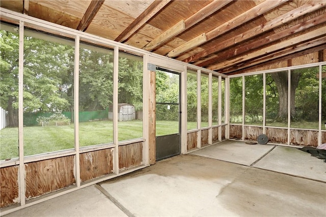 unfurnished sunroom featuring vaulted ceiling