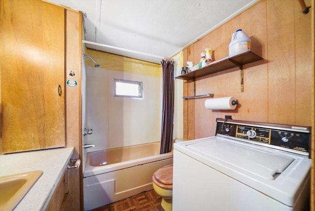 full bathroom featuring parquet floors, washer / dryer, toilet, shower / bath combo with shower curtain, and vanity