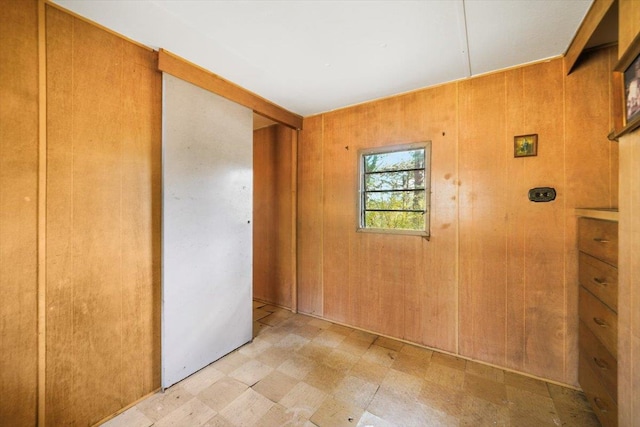 unfurnished bedroom with wooden walls