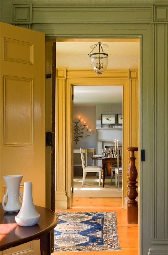 doorway with light hardwood / wood-style flooring and an inviting chandelier