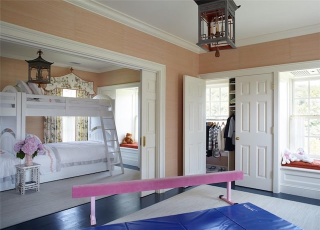 bedroom featuring hardwood / wood-style floors, a closet, and ornamental molding