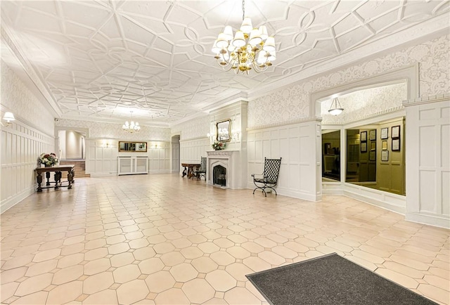 unfurnished living room with crown molding and an inviting chandelier