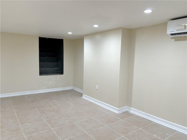 spare room with a wall mounted air conditioner and light tile patterned floors