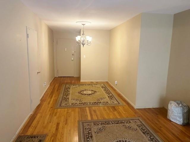 interior space featuring a chandelier and hardwood / wood-style floors