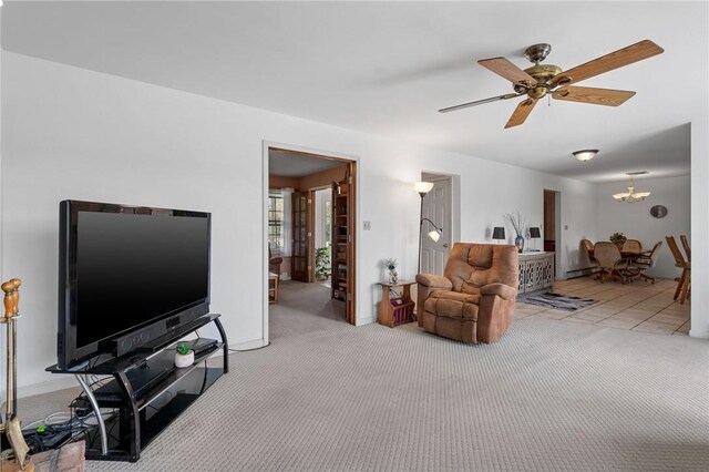 living room with light carpet and ceiling fan with notable chandelier