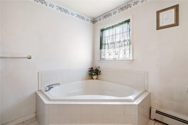 bathroom featuring tile patterned floors, tiled tub, and a baseboard heating unit