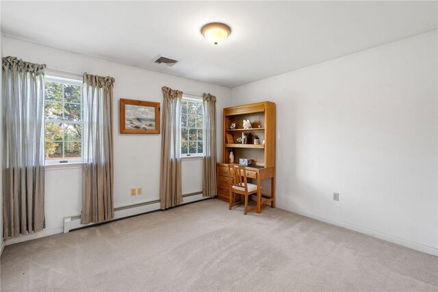 carpeted empty room with baseboard heating