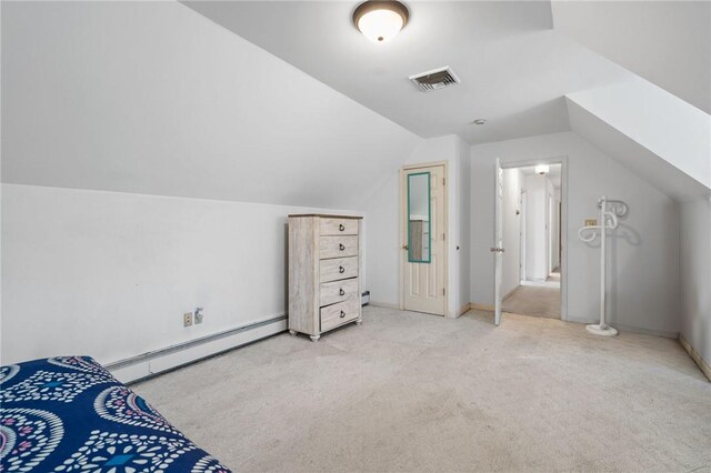 bedroom featuring lofted ceiling, light colored carpet, and a baseboard heating unit