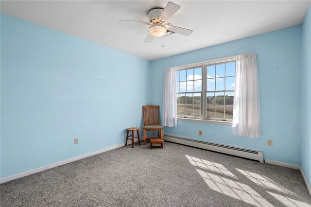 empty room with carpet, ceiling fan, and a baseboard heating unit