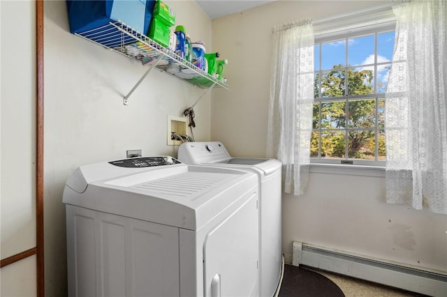 laundry room with a healthy amount of sunlight, washing machine and dryer, and a baseboard heating unit