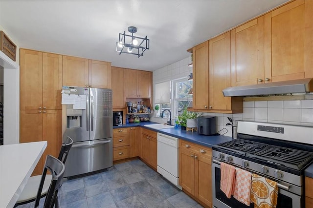 kitchen featuring decorative backsplash, light brown cabinets, sink, and stainless steel appliances