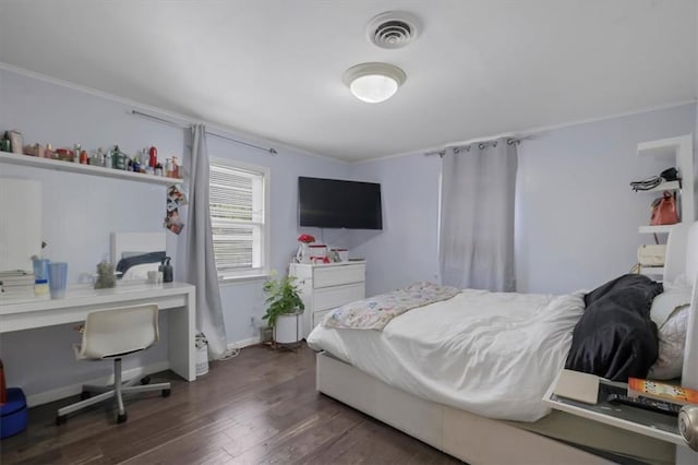 bedroom with dark hardwood / wood-style flooring and ornamental molding