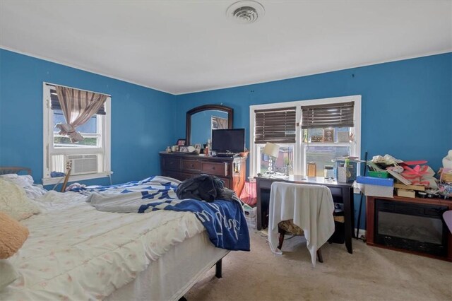 bedroom with light colored carpet and cooling unit