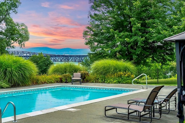 view of pool at dusk