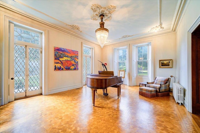 misc room with crown molding, radiator heating unit, a healthy amount of sunlight, and french doors