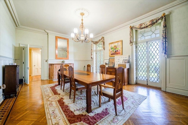 dining room with a chandelier, crown molding, parquet floors, and a healthy amount of sunlight