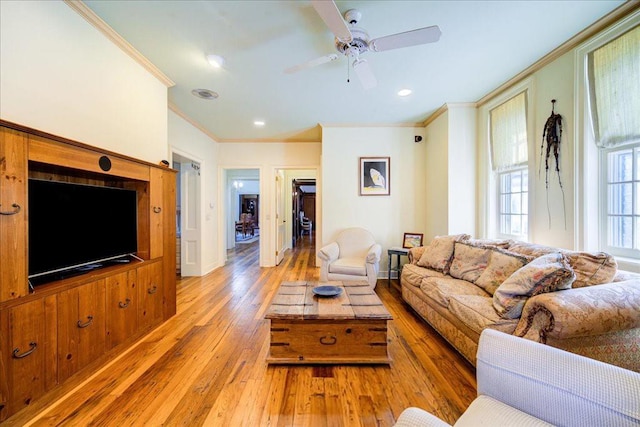 living room featuring crown molding, light hardwood / wood-style flooring, and ceiling fan