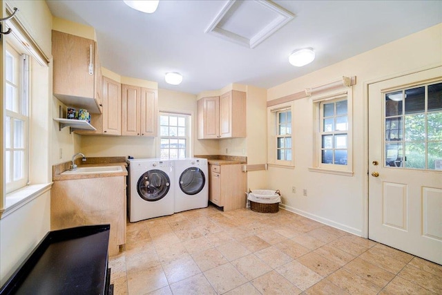 laundry room with cabinets, washer and dryer, and sink