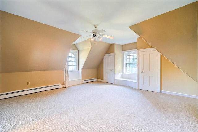 bonus room with carpet flooring, lofted ceiling, a wealth of natural light, and a baseboard radiator