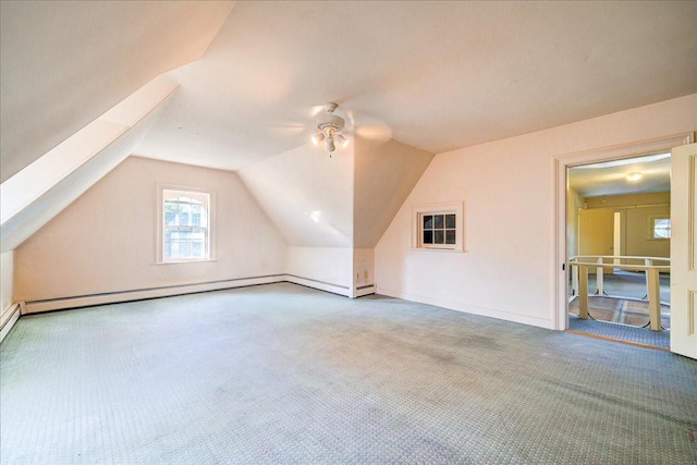 bonus room with light colored carpet, vaulted ceiling, ceiling fan, and a baseboard radiator