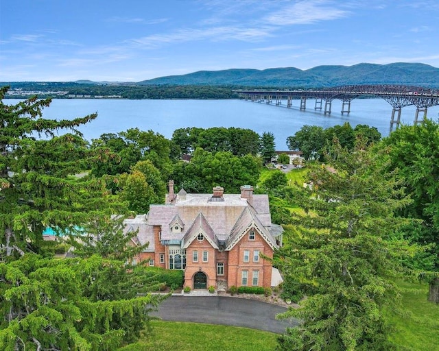 drone / aerial view with a water and mountain view