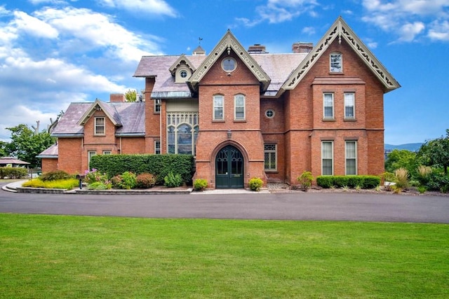 view of front of house with a front yard and french doors