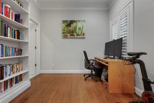 home office with hardwood / wood-style floors and ornamental molding